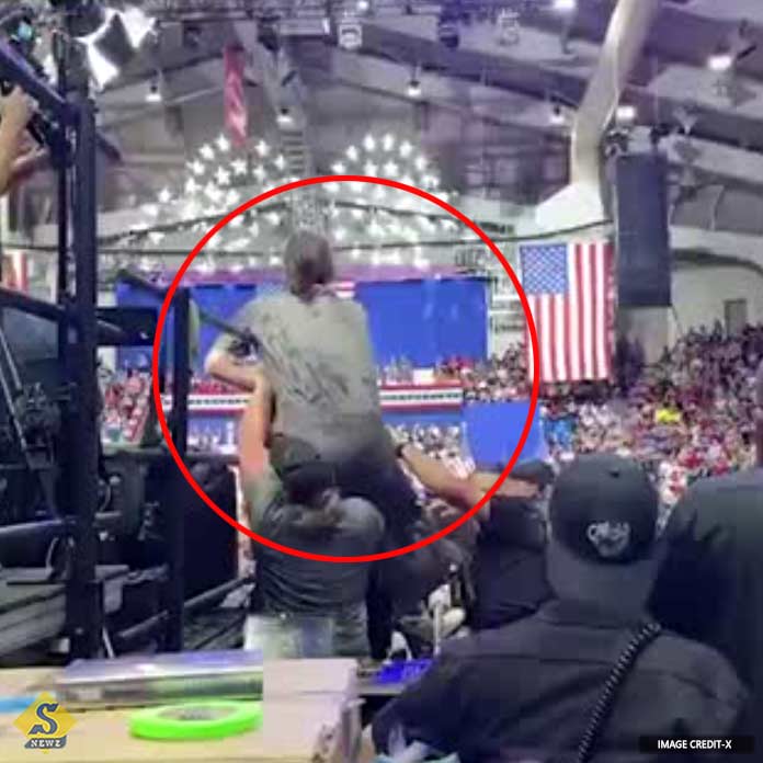 Young man tried to climb Trumps stage detained Young man tried to climb Trumps stage detained
